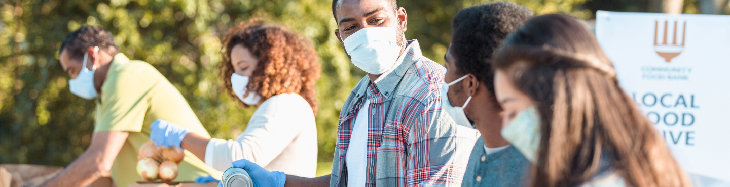 People with masks at a local food drive