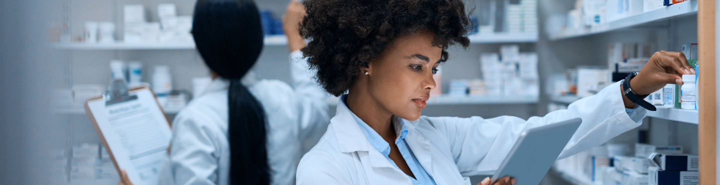 woman in pharmacy reading a tablet