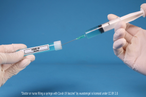"Doctor or nurse filling a syringe with Covid-19 Vaccine" by wuestenigel is licensed under CC BY 2.0
